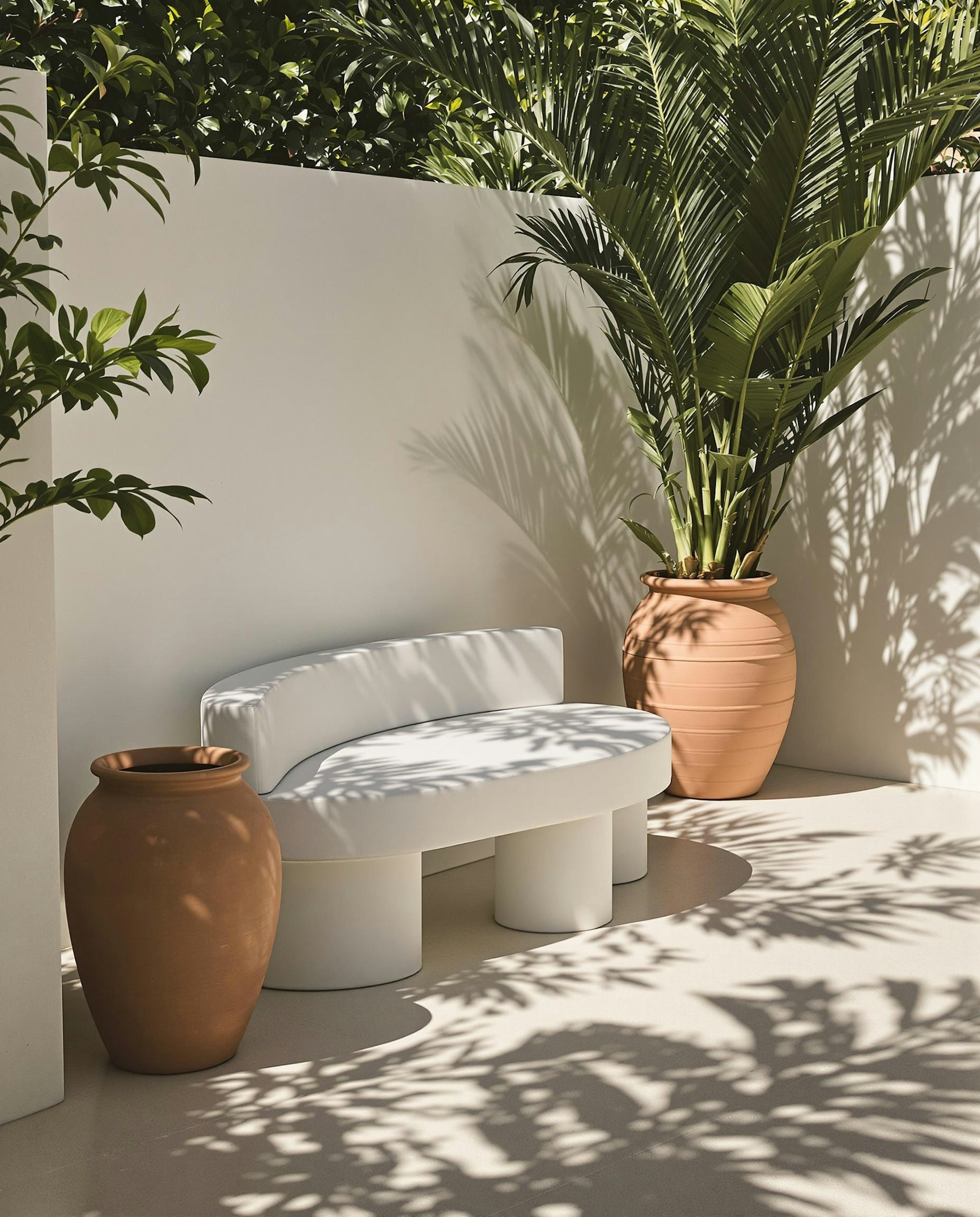 Outdoor seating nook shaded by linen canopy